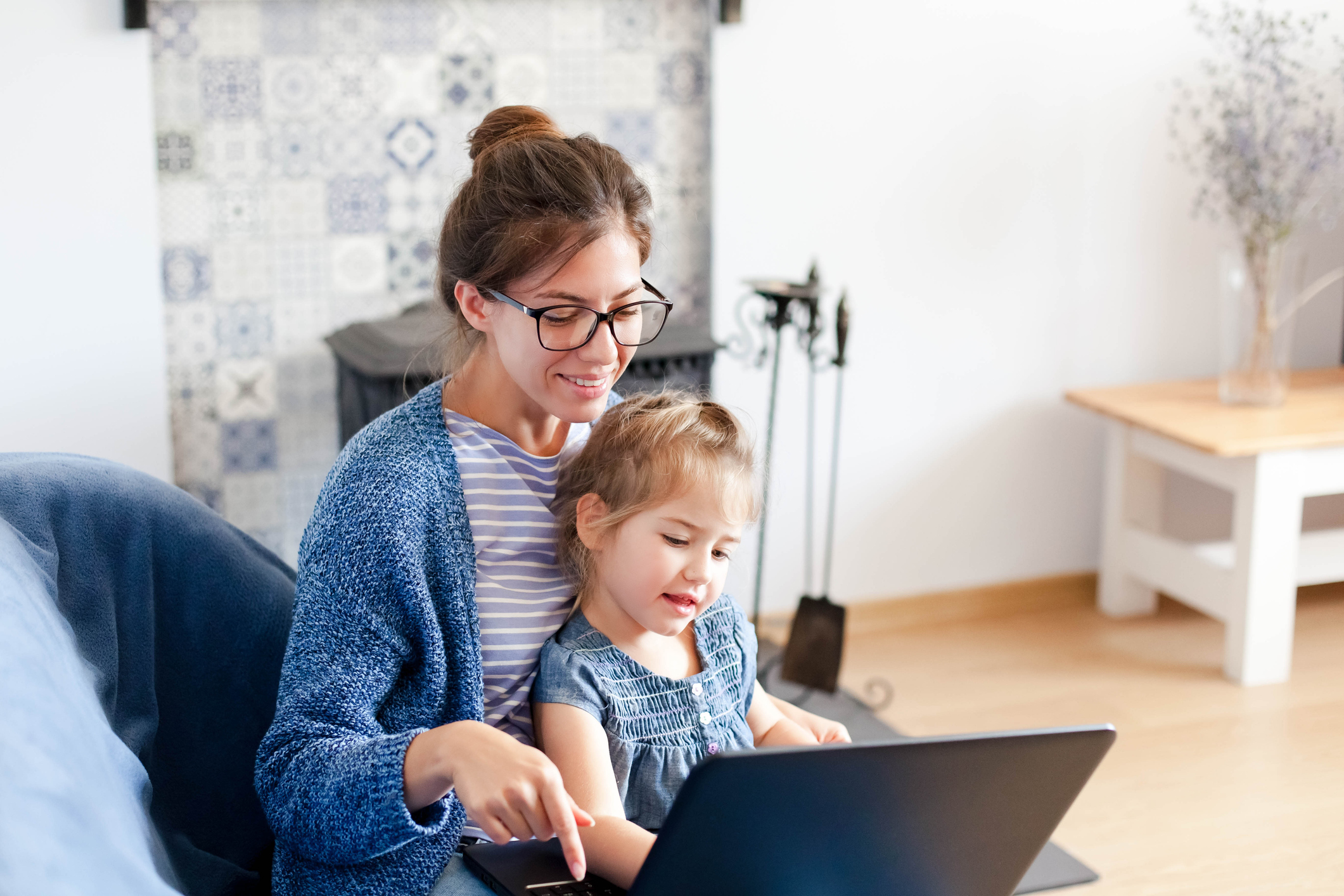 Young mother and daughter looking at a computer