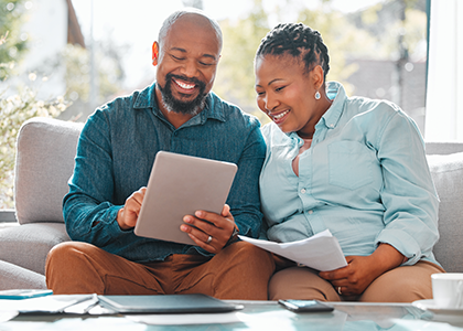 Couple looking at financial statements on a tablet