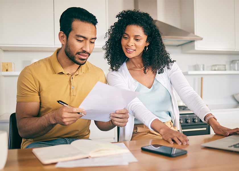 Couple, insurance paperwork and budget planning with laptop, bills and finance with taxes and mortgage. Financial documents, payment and loan with policy, audit and review with asset management.