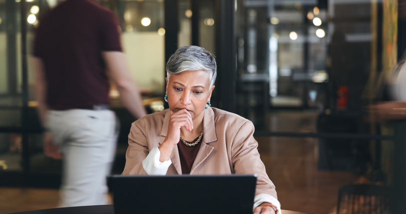 Worried individual contemplating their laptop. Crisis management and financial planning