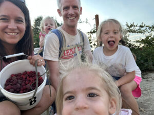 Larz and his family picking raspberries.