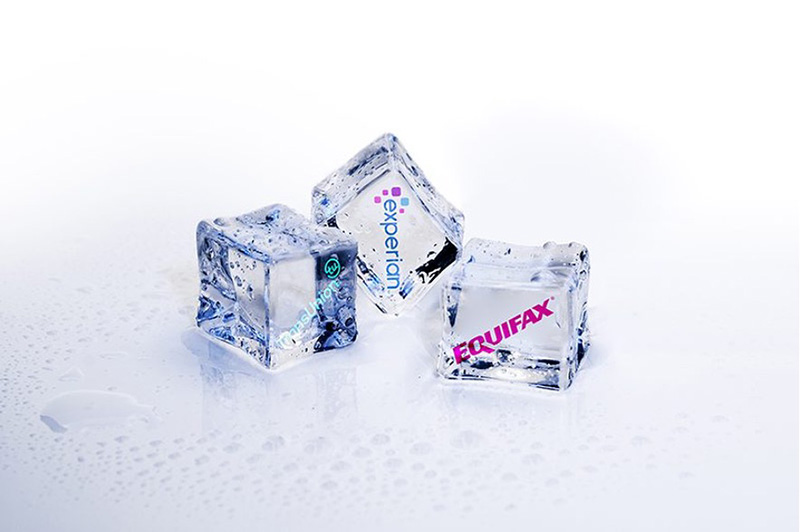 Ice cubes labeled Experian, TransUnion, and Equifax, symbolizing the concept of freezing your credit with the major credit bureaus.