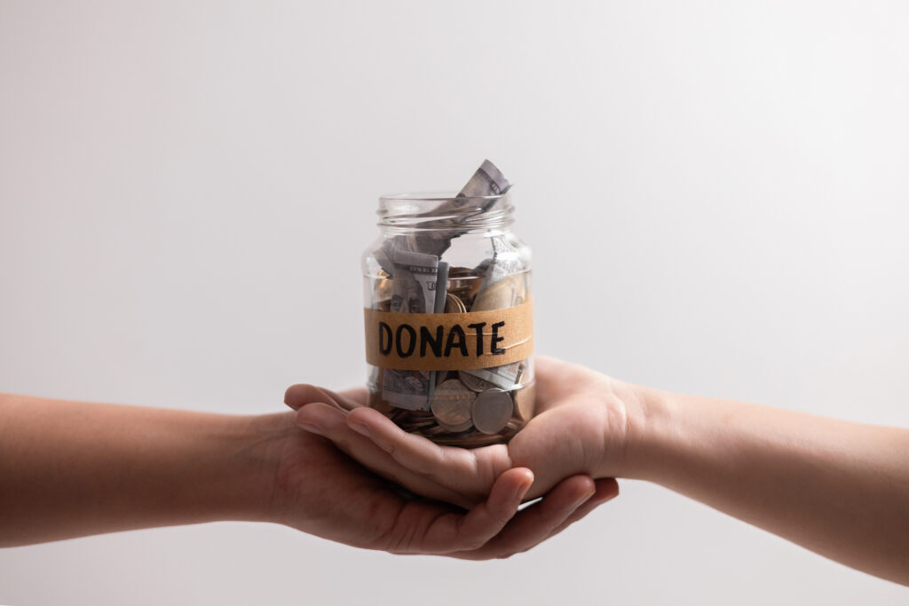 Manage her income wisely she used jar to save coins and cash, balancing her financial needs between finance and desire to donate money. money, coin, finance, jar, financial, save, cash, donate.